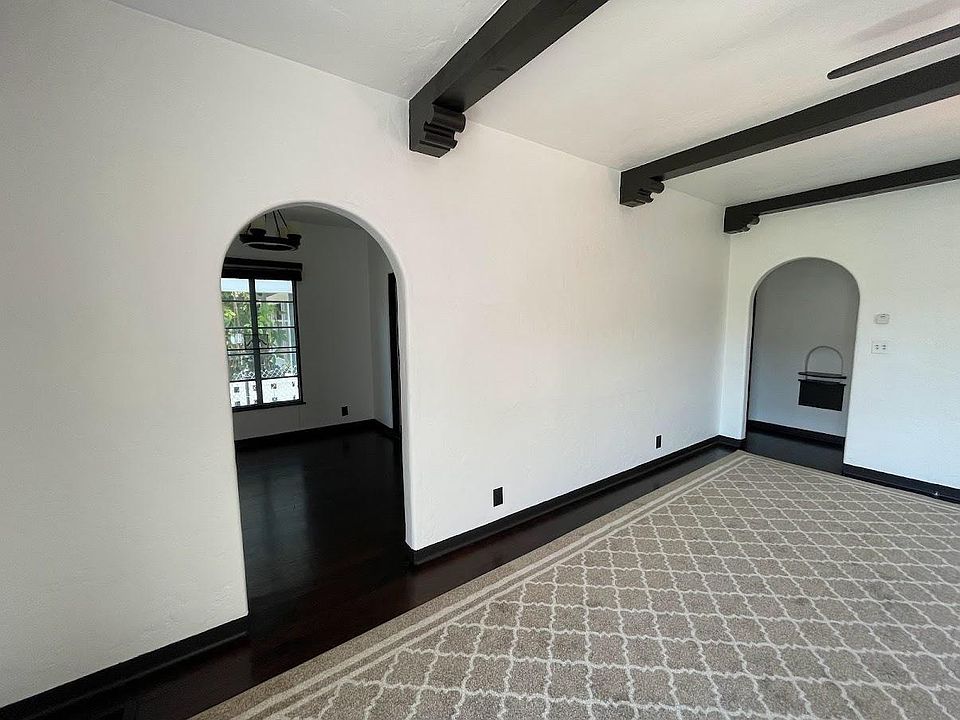 beautiful arched doorways, original wood beams, and original wood floors
