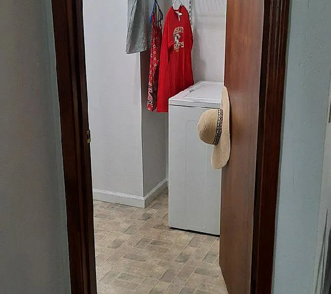 ...the separate laundry room (with door) hides dirty clothes and washing chores from the living areas and offers additional storage space with adjustable shelving....