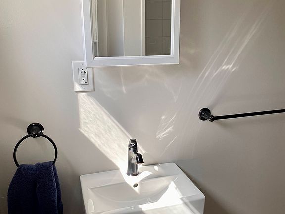Bathroom vanity with storage below, storage in medicine cabinet, and newer accessories.