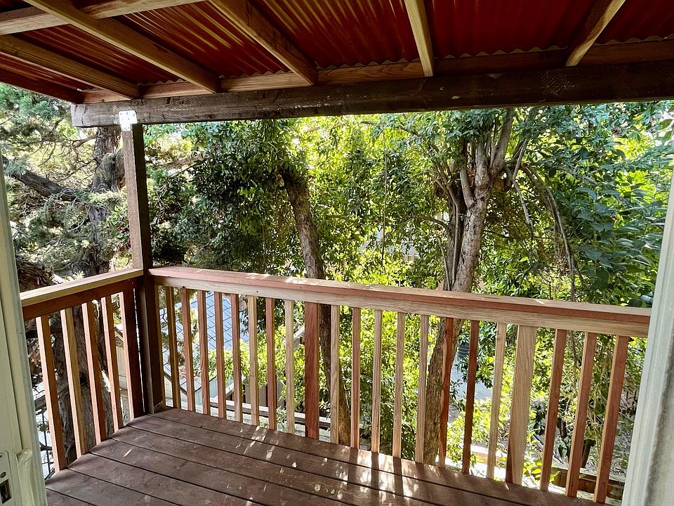 This private deck leads out from the bedroom into the fully-fenced, side yard.