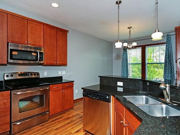 Note the upgrades- granite and stainless steel appliances along with beautiful cabinets.