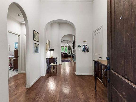 Arched entryway with hardwood floors. Harwood flooring in the entry, formal dining room, kitchen, breakfast and family rooms. Floors are in beautiful condition.