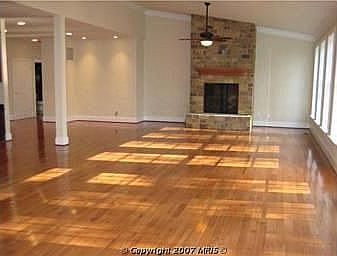 Family Room with panoramic views of the lot and natural stone fireplace.