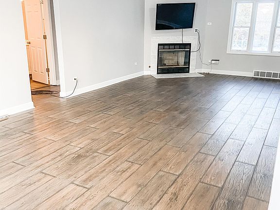 Large double size living area with fireplace and mounted flat screen