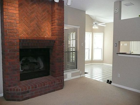 RED BRICK FIREPLACE WITH TRACT LIGHTING AND GAS LOGS