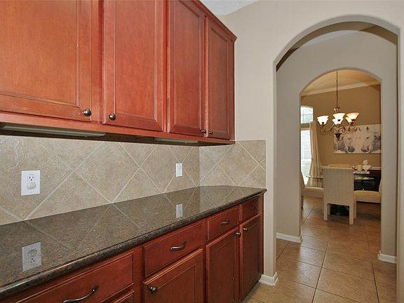 Between the kitchen and the dining room is a this convenient Butler's Pantry with granite counters.