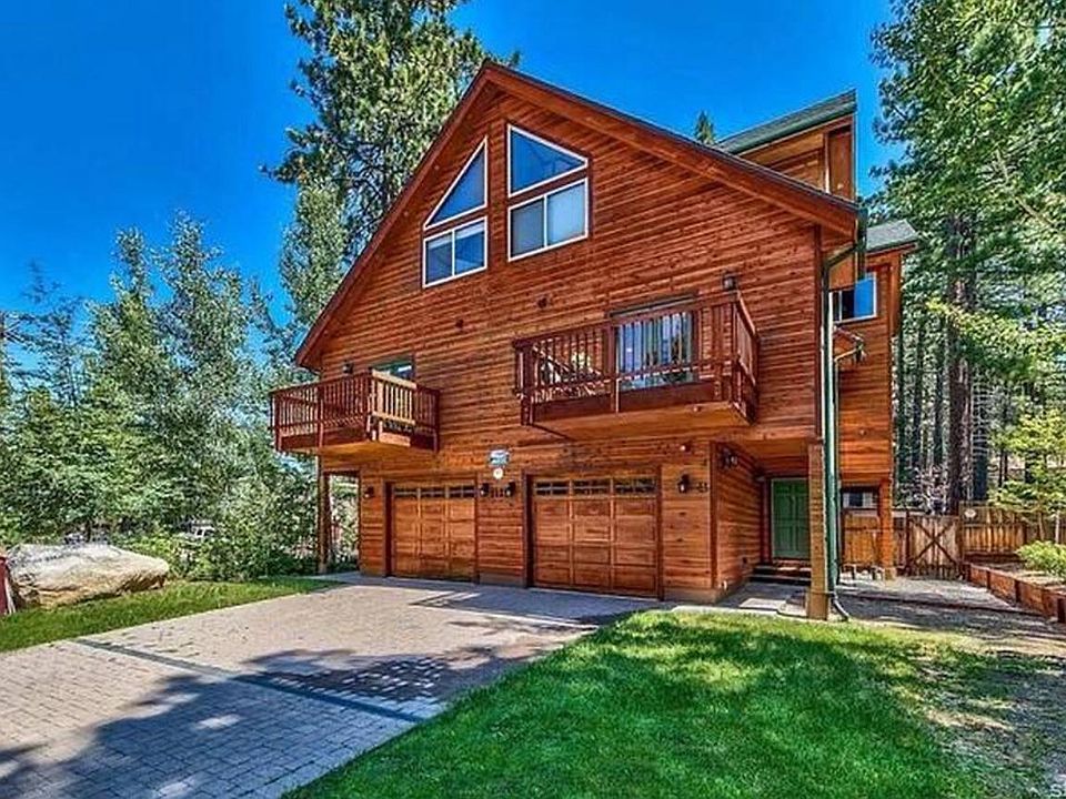 This inviting exterior of the shared duplex perfectly captures the charm of South Lake Tahoe. With its beautiful architecture, spacious deck, and lush landscaping, it's ideal for relaxation and gatherings. Enjoy stunning mountain views.