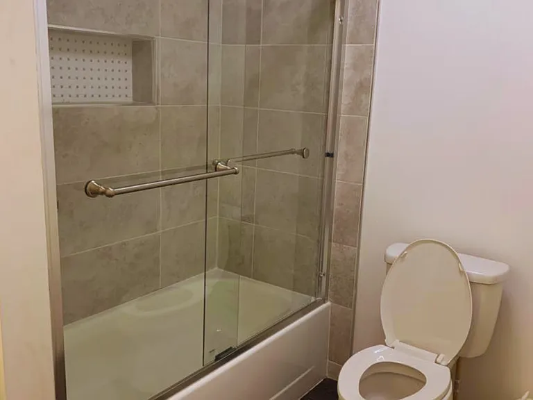 Glass-Enclosed Shower with Spotless Bathroom.
