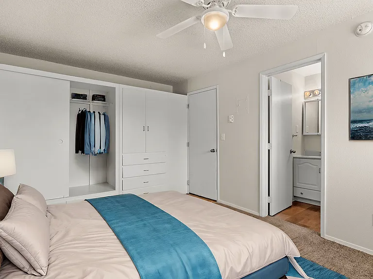 Cozy and functional bedroom, virtually staged to highlight built-in storage, soft carpeting, and a clean, modern design.