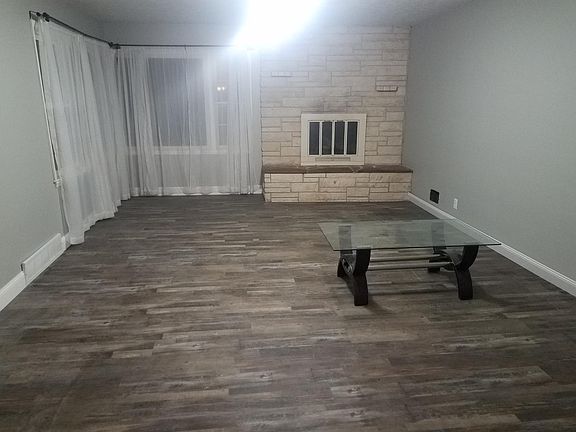 Living room.  fireplace, ceiling, fan, vinyl plank (water pr