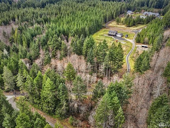 Only one house behind, and fully shielded by trees and fence. This property runs all the way to the road at the bottom of this photo.