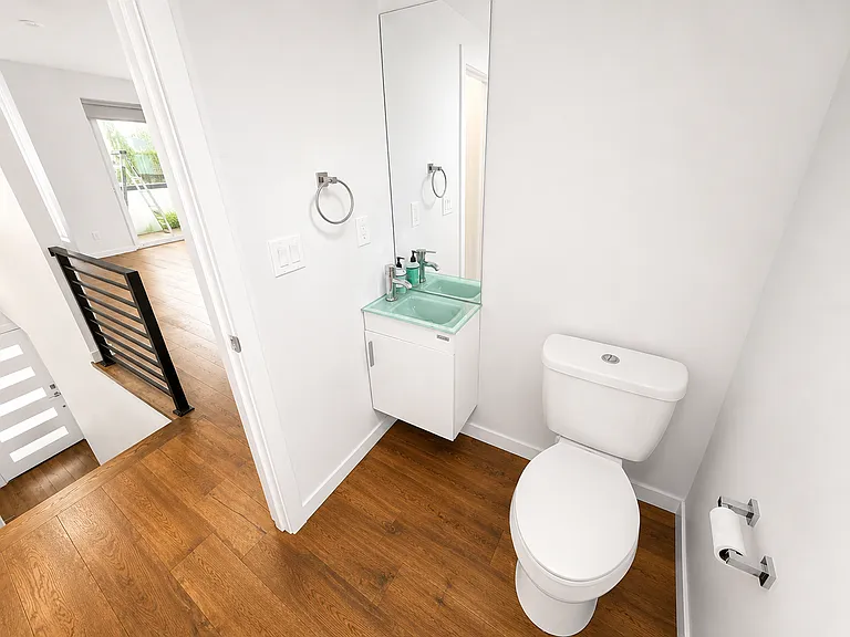 Half bathroom just off kitchen and living room space