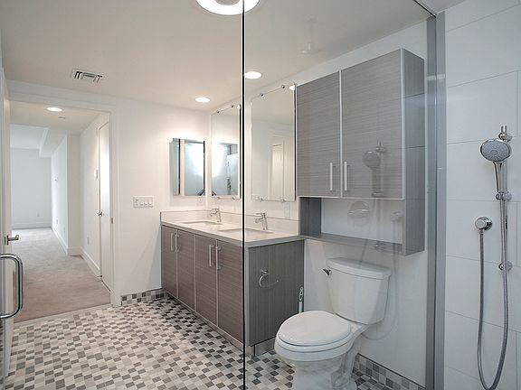 Spacious Bathroom with Large Stand-Up Shower, Double Vanity, and Cabinet Storage