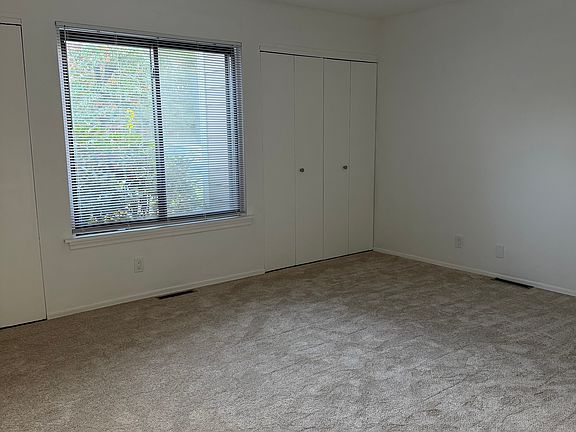 Large Bedroom With New Carpet and Two Closets