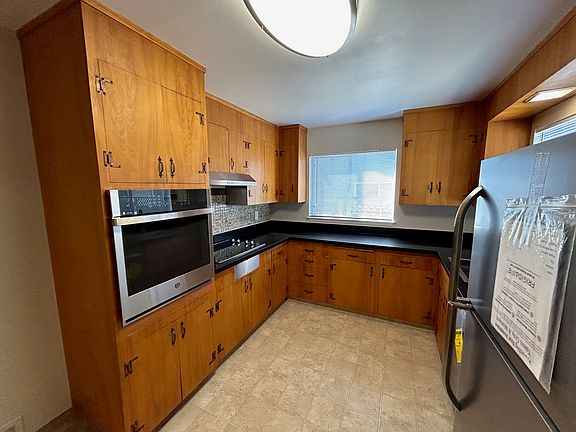 Kitchen offering all new appliances, including dishwasher, wall oven, electric range, and fridge/freezer.