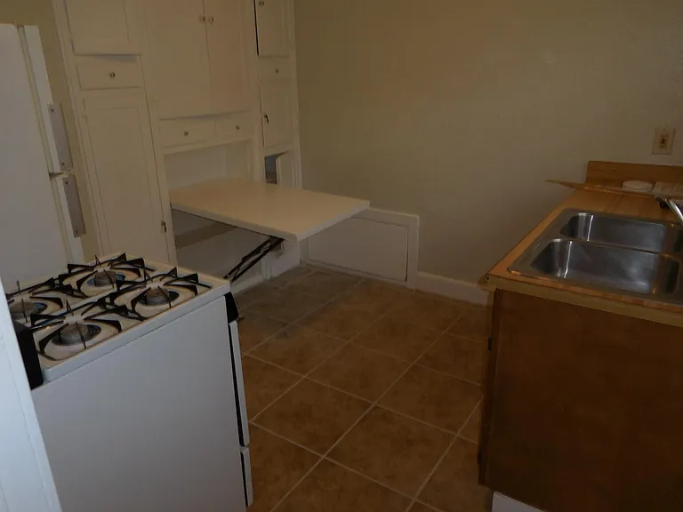 The table has a bench seat on the wall