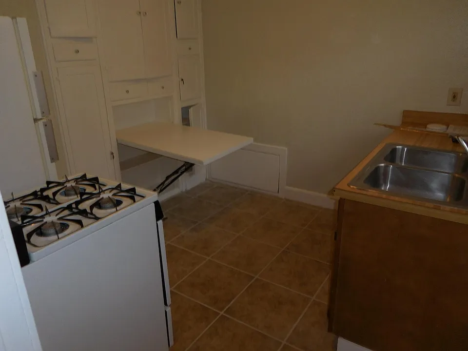 The table has a bench seat on the wall