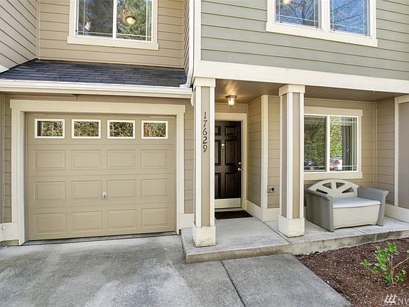 Attached 1 car garage with extra parking in driveway. Across the street is a green belt adding additional privacy off the front porch.