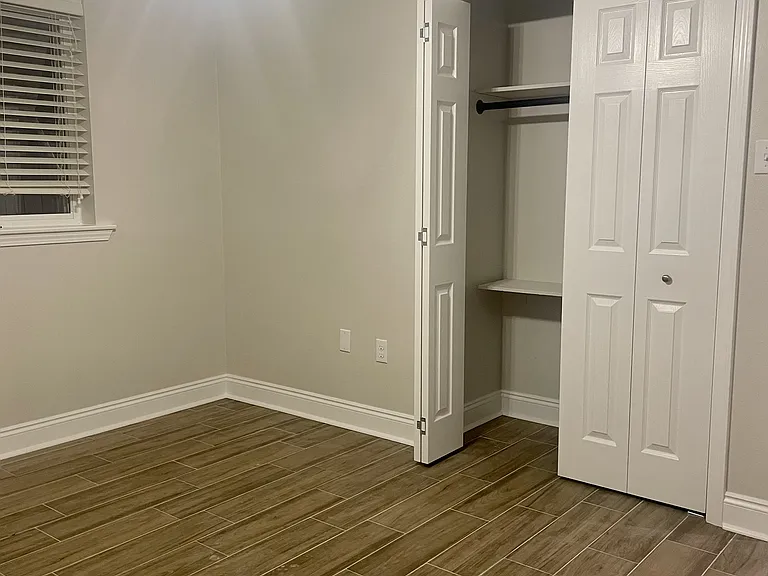 Spacious guest bedroom (3/4) featuring a closet and easy access to the hall bathroom.