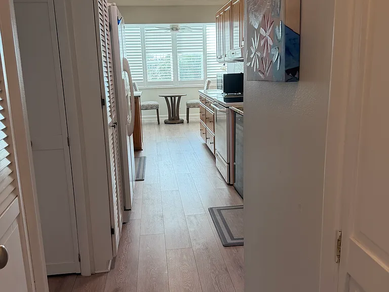 View down hall into kitchen. Love the long counters and lots of cabinets.