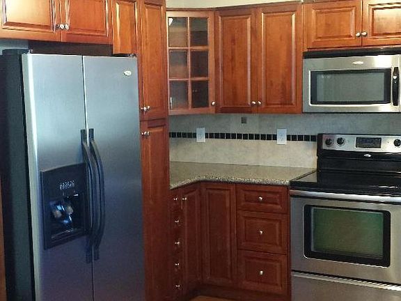 Kitchen: side-by-side refrigerator/freezer with ice/water in door.