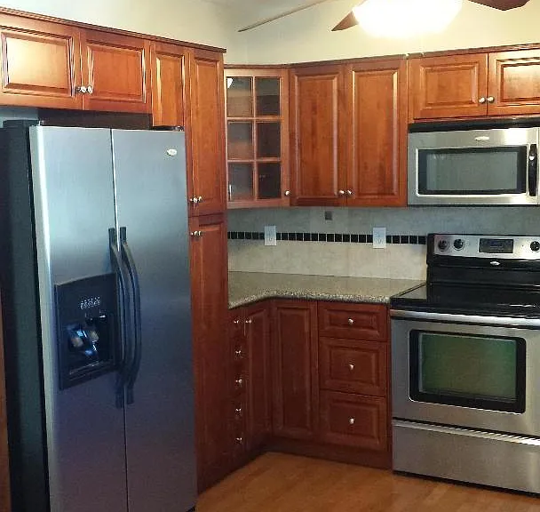 Kitchen: side-by-side refrigerator/freezer with ice/water in door.