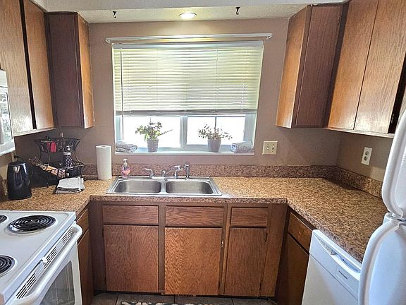 Warm, inviting and cozy kitchen includes, over the range microwave, dishwasher, fridge, range, and garbage disposal.