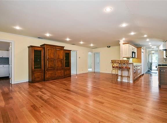 Stepping in from the front door looking into main living area.  Office to the left, bedrooms beyond, updated kitchen with granit