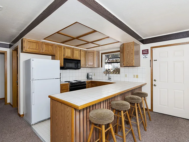 Upstairs fully stocked kitchen, island bar and door to outside Hot Tub and 360 walk around HUGE deck.
