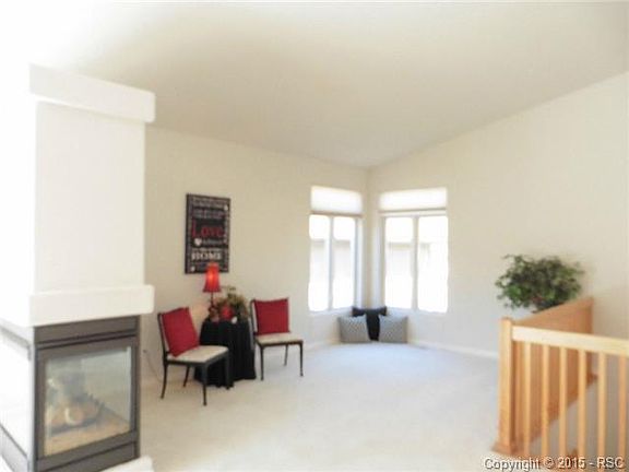 Triple-sided gas fireplace for cozy entertaining.  Vaulted ceili
