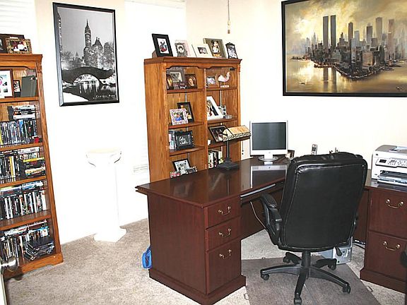Nice home office or study with French doors and a ceiling fan with light kit. Great space!