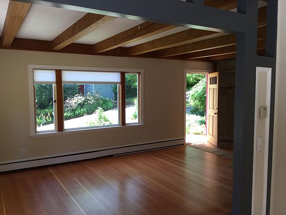 looking out front door toward 73 rd st, old wood beams, floors just refinished, new paint, new blinds
