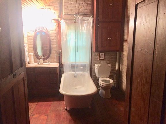 Claw foot bath tub with shower. Also, much storage