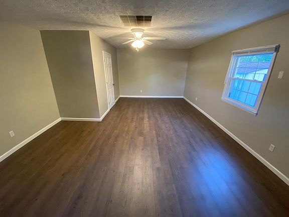 This room is absolutely huge and could be a master bedroom or family room. It has a spacious walk-in closet. New flooring, new fan and paint.