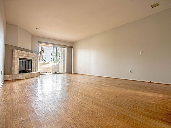 view of the livingroom/patio (the hardwood floors have been refinished since this photo was taken)