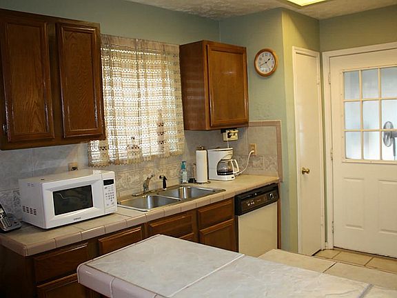 Kitchen with lots of cabinets & microwave stays.