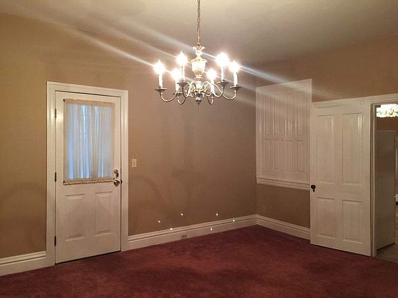 Door to small enclosed porch onto deck, from Dining Room