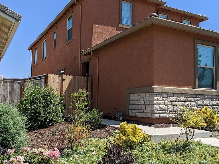 Charming curb appeal. This view showcases the home's modern design, stone accents, and manicured landscaping, creating a welcoming first impression.