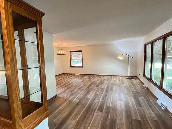 Entry to front family room, wood floor, two built-in cabinets, new light fixtures.