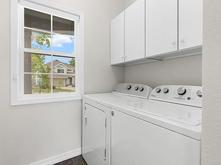 A separate laundry room includes built-in cabinetry for additional storage and everyday convenience.