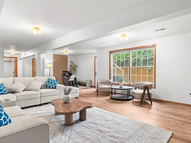 Spacious basement recreation lounge with generous seating and plenty of open space for relaxing, entertaining, or gathering with family and friends.