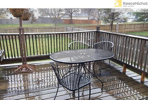 Deck overlooks large fenced yard