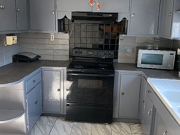 Kitchen has exit back door.