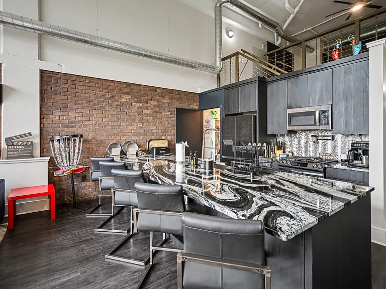 Lots of storage options under the island on both sides. Hidden outlets in the island make it a great spot to enjoy an espresso drink from the fully automated coffee machine while checking emails in the morning.