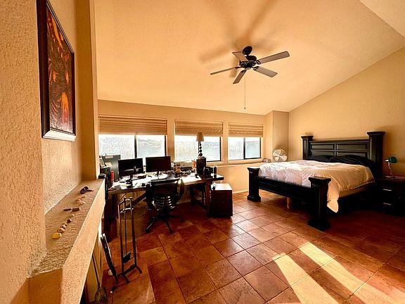 Master bedroom in spacious loft with vaulted ceilings dedicated work area, master bath with dual-vanity sinks, tub/shower, large walk-in closet, and amazing views