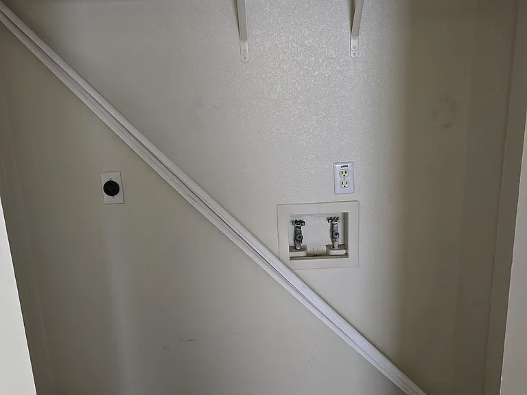 laundry area with closing doors