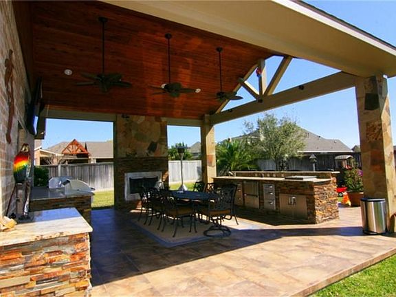 Breath taking Custom Outdoor Patio with Stone Gas Log Fireplace.