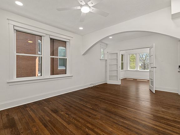 Spacious living room. New double pane energy efficient windows, upgraded can lights and remote powered fan. Fresh alabaster white paint.

Front bedroom seen from the living room.