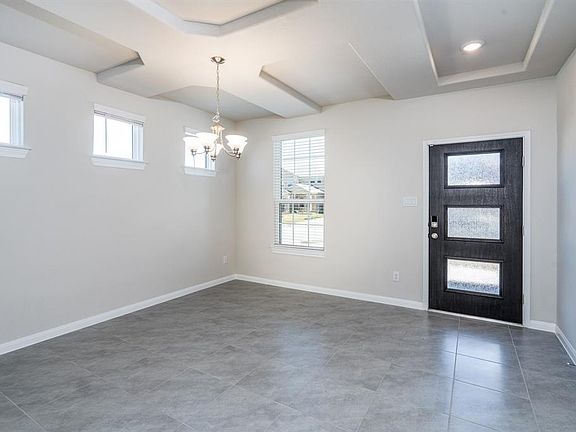 At the front of the home is the large dining room with windows that fill the room with natural light.