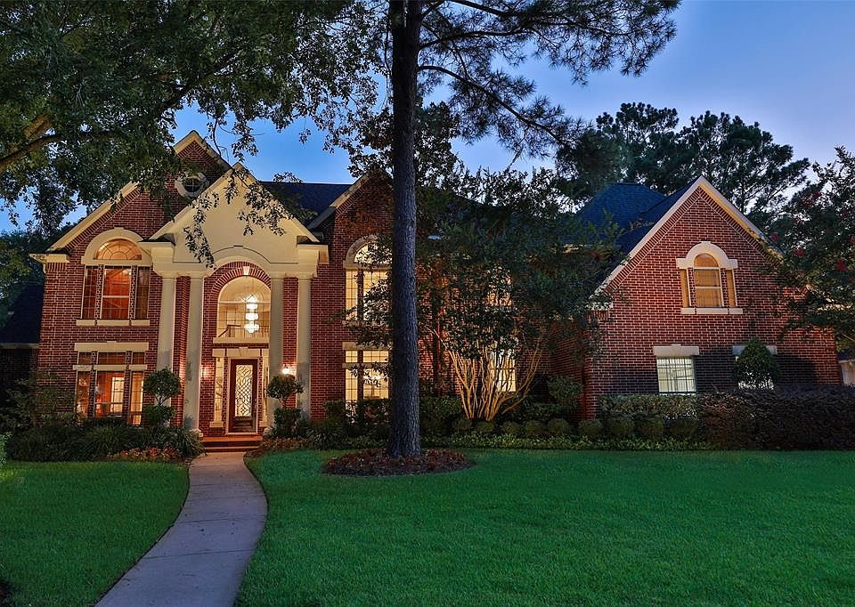 BUILDERS CUSTOM HOME ON AN IMPRESSIVELY BEAUTIFUL TREE LINED STREET IN CHAMPION FOREST - This stately home rests on over a 14,000 sq ft lot. Brand new roof in 2020, an abundance of parking with an over-sized 3 car parking garage & extended driveway. 